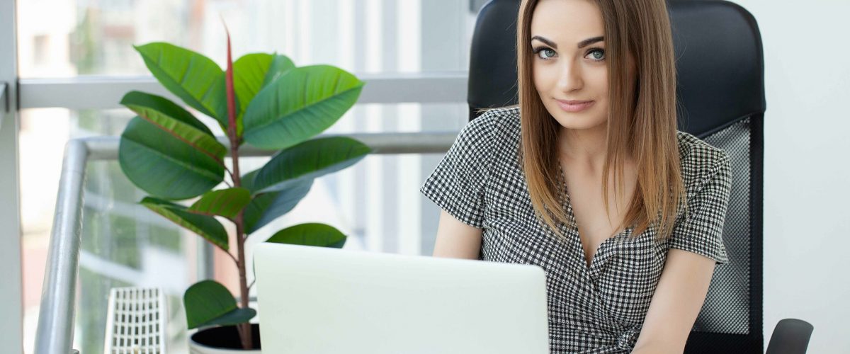 beautiful-business-woman-is-using-laptop-smiling-while-working-office